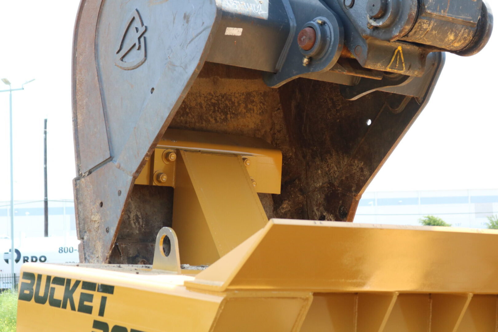 Big Construction Bucket using Bucket Bozz Excavator Cleaning Tool