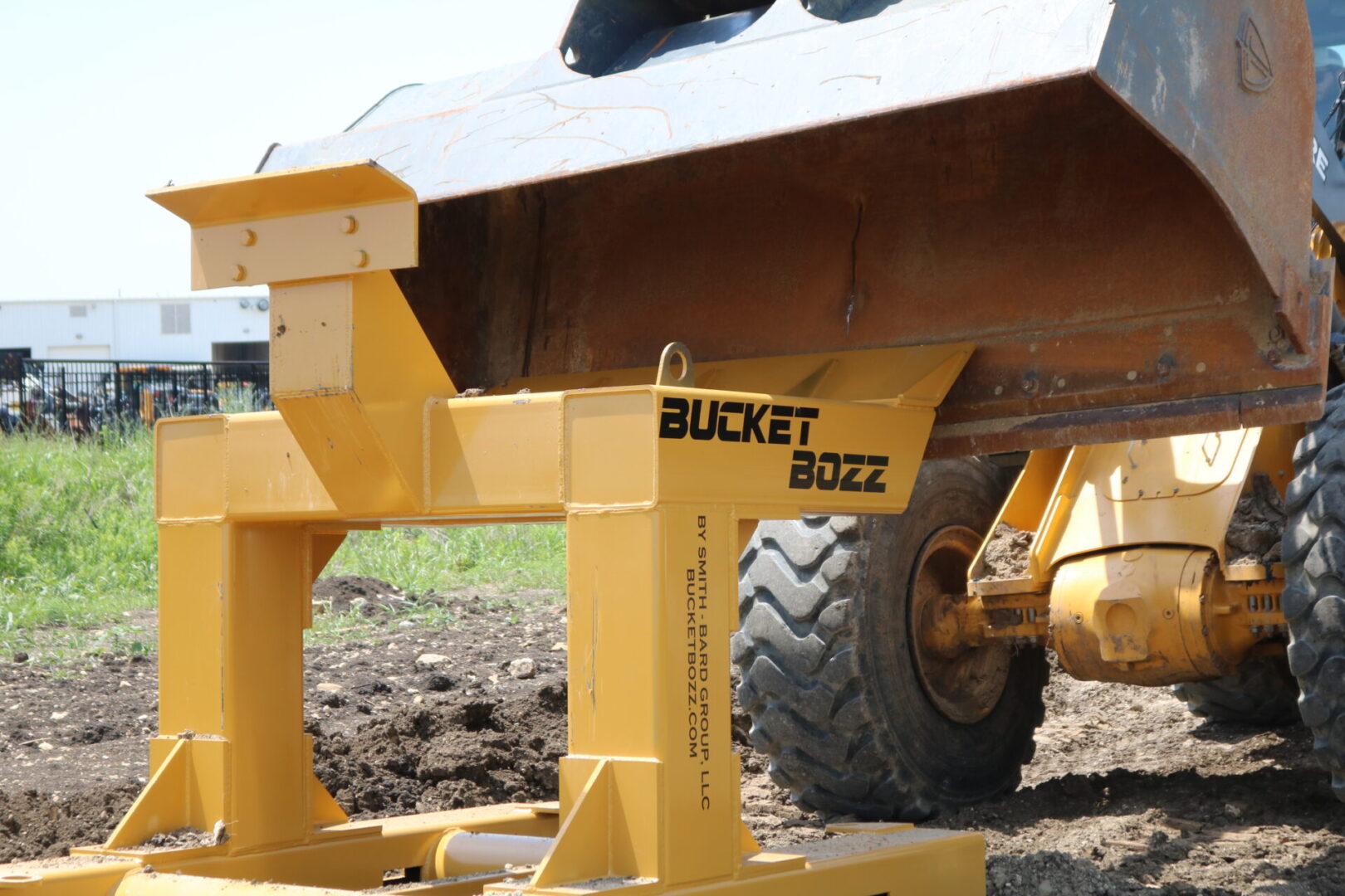 Large Loader Bucket making contact with Bucket Bozz Hard Mount Cleaning Tool