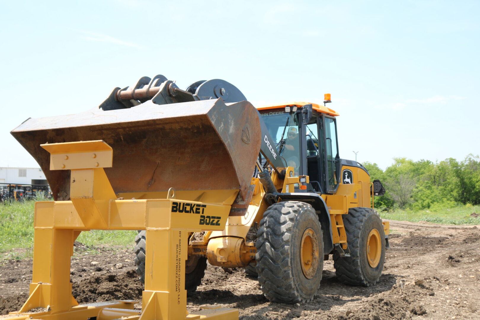 Large Loader Bucket making contact with Bucket Bozz Hard Mount Cleaning Tool